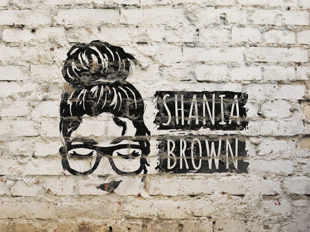 Shania Brown logo painted on brick wall